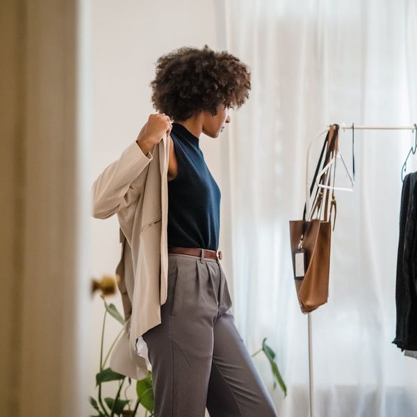 Person meditating in a bright, minimalist room, conveying a sense of peace.